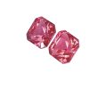 Close-up of faceted pink crystals arranged diagonally on a white background, showing their sharp geometric faces.