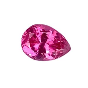 Pear-shaped pink gem with brilliant facets on a white background, likely a pink diamond or sapphire.