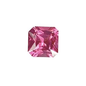 Partial view of a faceted pink gemstone against a white background in a gemstone-cut shape