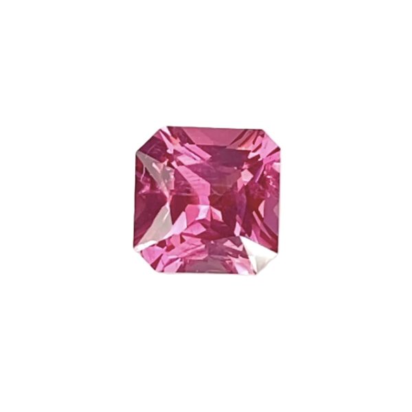 Partial view of a faceted pink gemstone against a white background in a gemstone-cut shape