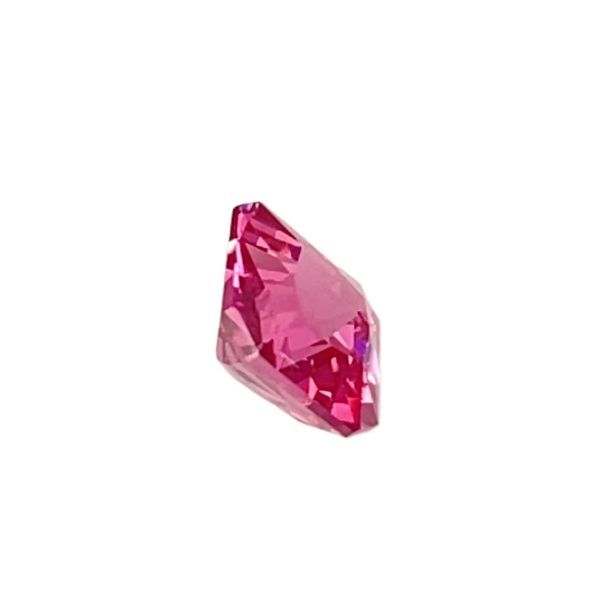 Pink faceted gemstone crystal on a white background with shining facets