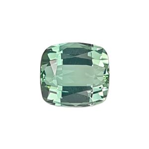 Close-up of a faceted green gemstone with emerald-cut facets showing a deep, reflective green color.