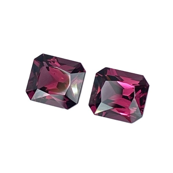 10_4 - GEMWORLD LTD Two faceted, purple-pink gemstones on a white background