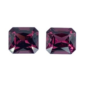 10_6 - GEMWORLD LTD Two faceted square-cut purple gemstones placed side by side on a white background