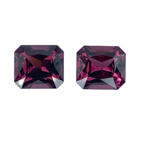 10_6 - GEMWORLD LTD Two faceted square-cut purple gemstones placed side by side on a white background