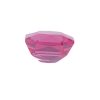 Partial view of a pink faceted gemstone, showing its angular cuts and bright pink color