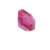 Close-up of a faceted pink gemstone against a white background, showing sharp angular facets.