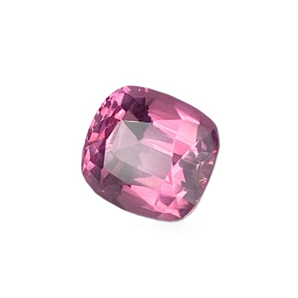 PSpin 21_1 - GEMWORLD LTD Close-up of a pink faceted gemstone cut in an oval shape on a white background.