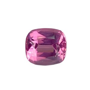 Close-up of a large faceted pink gemstone against a white background.