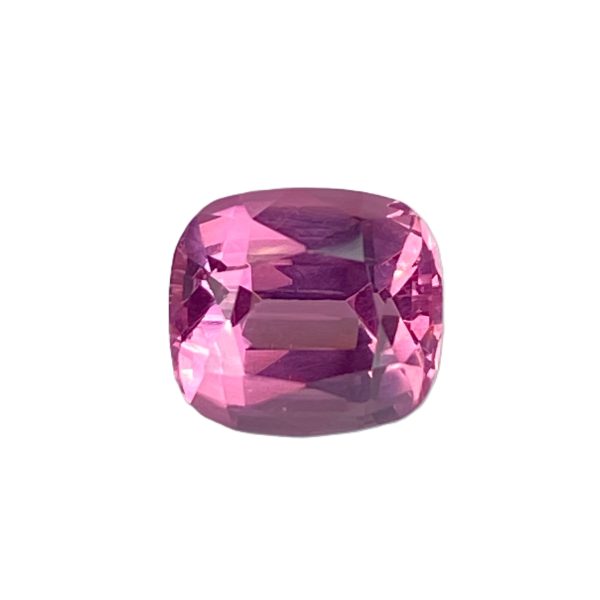 PSpin 21_3 - GEMWORLD LTD Close-up of a large faceted pink gemstone against a white background.