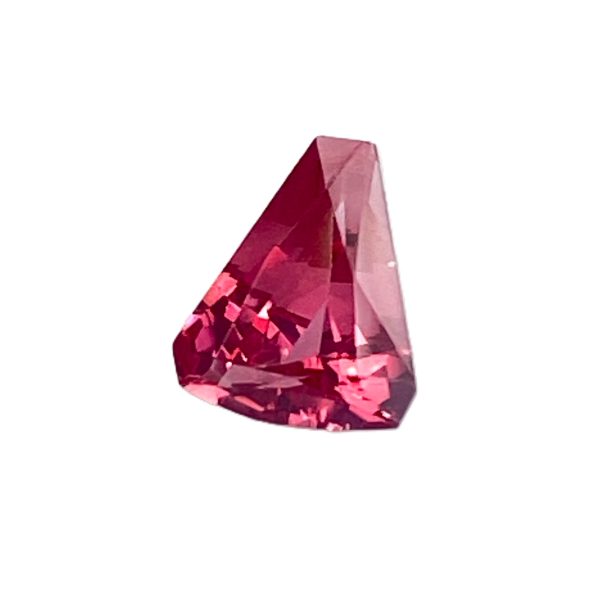 PSpin 42_5 - GEMWORLD LTD Close-up of a faceted pink gemstone crystal against a white background.