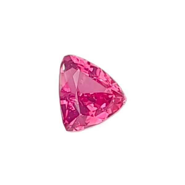 Close-up of a faceted pink gemstone on a white background.