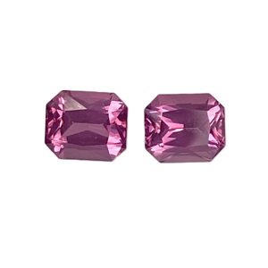 Two pink-purple faceted gemstones placed side by side on a white background (jewelry-like cut stones).