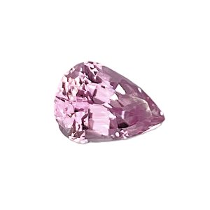 Close-up of a faceted pink gemstone with a rounded triangular shape