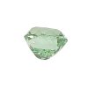 Green faceted gemstone, close-up showing multiple facets and a pale hue