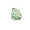 Close-up of a pale green faceted emerald gemstone.