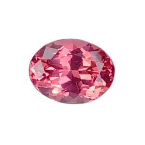 Partial view of a pink faceted gemstone ball with many angular facets.