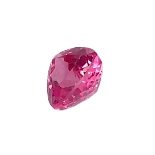 Faceted pink gemstone shaped like a rounded heart, showing many reflective facets against a white background.