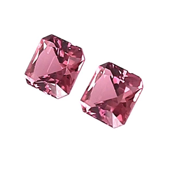 157_3 - GEMWORLD LTD Two pink, square-cut, faceted gemstones on a white background.