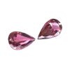 Tour 124125_2 - GEMWORLD LTD Two pink faceted teardrop gemstones on a white background.