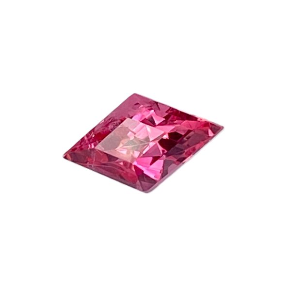 PSpin 113_1 - GEMWORLD LTD Pink faceted gemstone (cut-cornered diamond) with multiple angular facets, tilted diagonally across the frame.