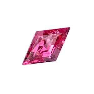 PSpin 113_2 - GEMWORLD LTD Pink faceted gemstone with a rectangular shape, angled against a white background.