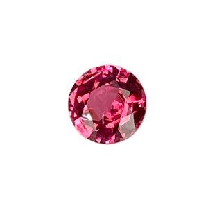 PSpin 118_1 - GEMWORLD LTD Close-up of a pink faceted gemstone (oval cut) with many reflective facets, shown partially in view.