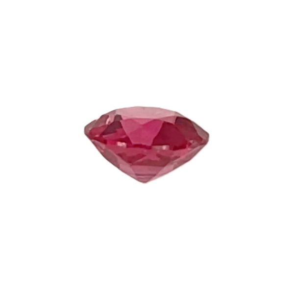 PSpin 118_6 - GEMWORLD LTD Faceted pink gemstone resting on a white background, showing multiple angular facets.