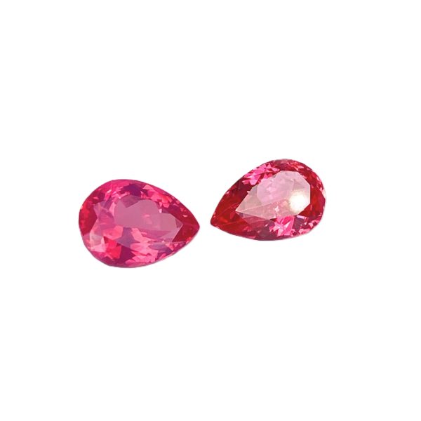 PSpin 138_2 - GEMWORLD LTD Three pink faceted gemstones arranged on a white background, showing bright facets and depth.