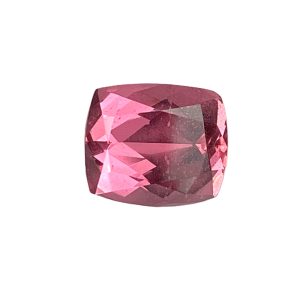 Close-up of a faceted pink gemstone with numerous angular facets reflecting light