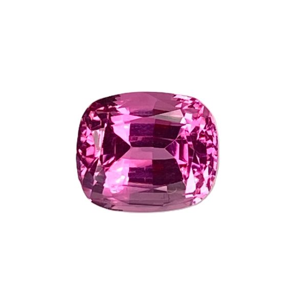 PSpin 71_3 - GEMWORLD LTD Close-up of a pink faceted gemstone with an oval cut, sparkling facets.