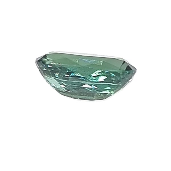 Korn 158_5 - GEMWORLD LTD Emerald-cut teal-green gemstone with facets, photographed on a white background