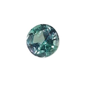 Korn 15_1 - GEMWORLD LTD Round faceted teal gemstone sparkling with blue-green hues in a brilliant-cut facet