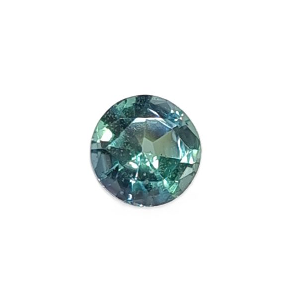 Oval-cut green-blue gemstone with facets reflecting light, top-heavy composition visible against white background.