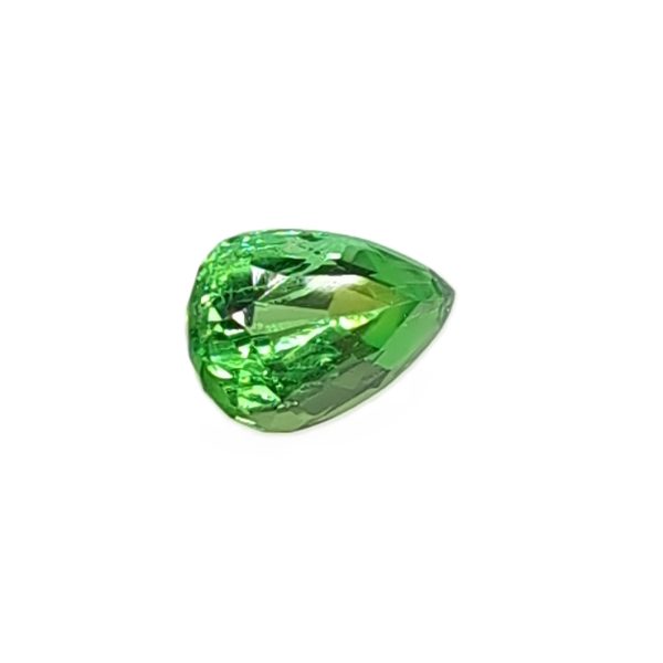 Green faceted gemstone with multiple cuts on a white background.