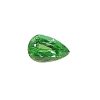 Emerald-green faceted gemstone peeking into the frame from the bottom-right against a white background