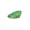 Emerald-cut green gemstone resting at the bottom-right on a white background.