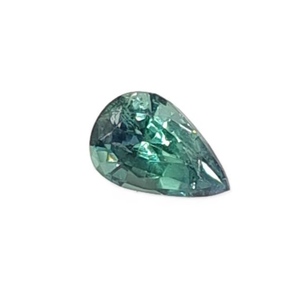 Korn 19_5 - GEMWORLD LTD Pear-shaped green gemstone with faceted surfaces on a white background.