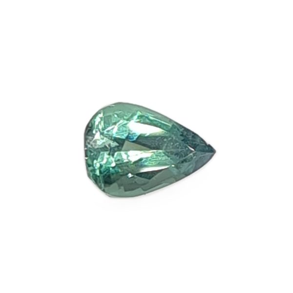 Korn 19_6 - GEMWORLD LTD Teardrop-shaped green gemstone with faceted surfaces on a white background, viewed close-up.