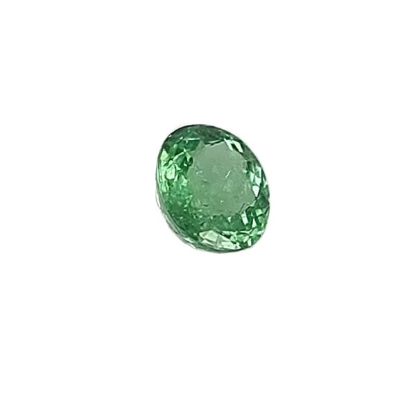 Par 16_7 - GEMWORLD LTD Close-up of a faceted green emerald gemstone against a white background