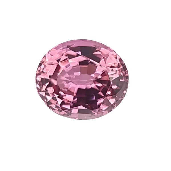 Partial view of a pink faceted gemstone sphere on a white background