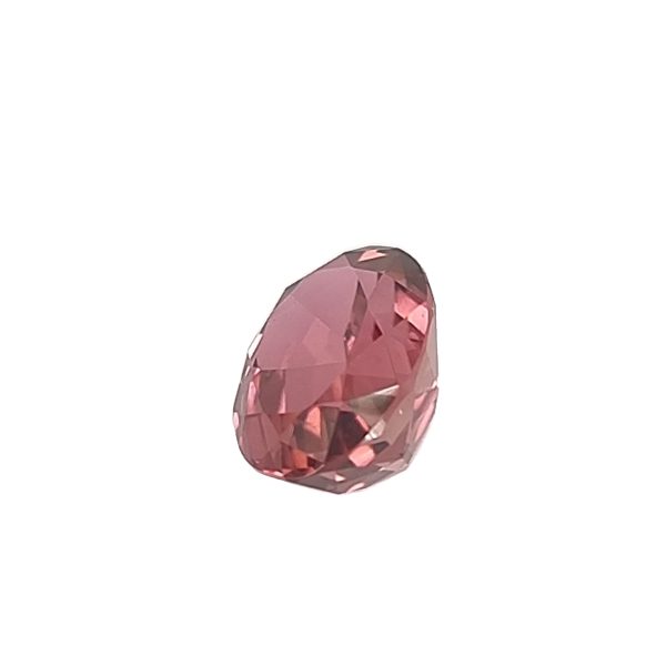 Tour 128_2 - GEMWORLD LTD Pink faceted gemstone with an oval shape, set against a white background.