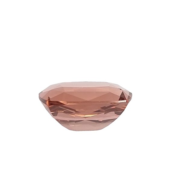 Tour 130_3 - GEMWORLD LTD Pink faceted gemstone (oval cut) resting on a white background.