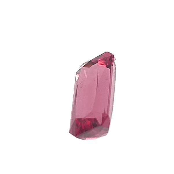 Tour 134_1 - GEMWORLD LTD Close-up of a pink crystal shard with faceted facets and a pointed tip