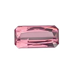 Tour 134_4 - GEMWORLD LTD Close-up of a pink faceted gemstone with angular cuts and reflections.