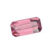 Tour 134_5 - GEMWORLD LTD Close-up of a faceted pink gemstone with angular, geometric facets against a white background.