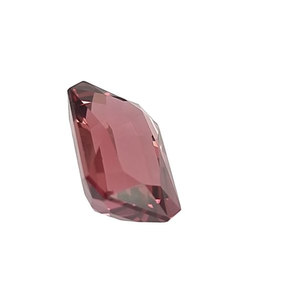 A pink faceted gemstone shown in a diagonal orientation against a white background.