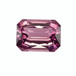 Close-up of a pink, faceted gemstone with many reflective facets on a white backgroundesh