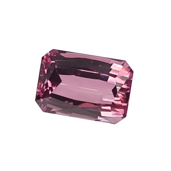 Pink faceted gemstone with rectangular-cut facets, close-up detail on a white background.