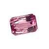 Close-up of a faceted pink gemstone with multiple angular facets against a white background.